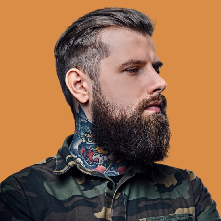 portrait-of-bearded-tattooed-hipster-male-dressed