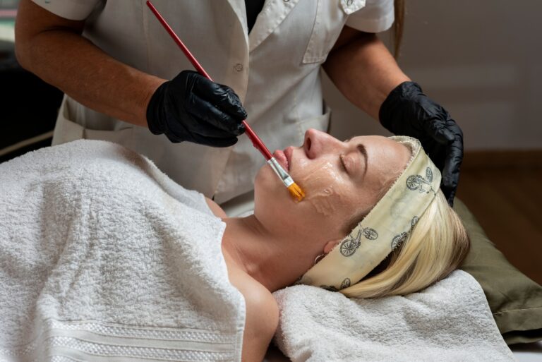 Woman performing an aesthetic treatment on the face of a patient