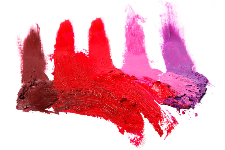 Different multi colored samples of a smudged lipstick